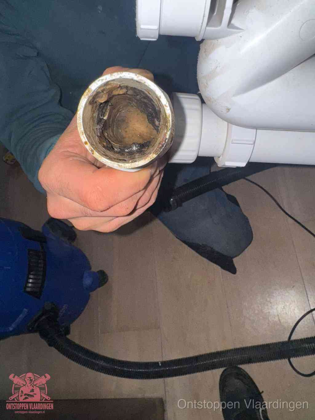Een losgekoppeld afvoerbuisstuk dat van binnen volledig is dichtgeslibd, het gevolg van een verstopping te lang laten zitten in Vlaardingen